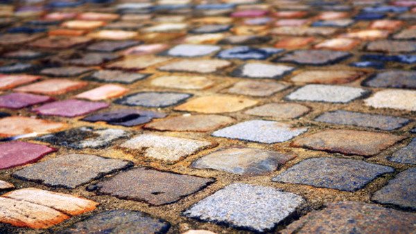 Background of colorful cobblestone pavement close up