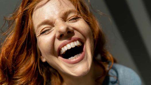 Portrait of laughing redheaded woman