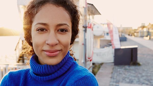 Swedish for asylum seekers. Woman on sidewalk.