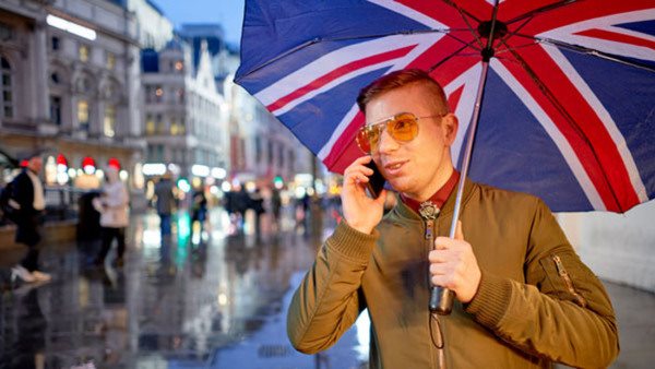 With a union jack umbrella, at Piccadilly Circus, London. England.