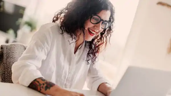 Kvinna deltar engagerat i kurs online, fokuserad framför sin laptop