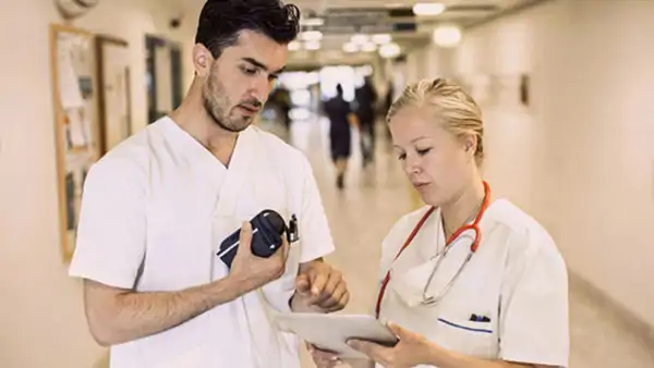 Two medical staff members engaged in discussion