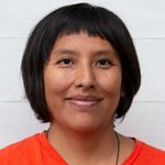 Teresa Alton Borgelin har en mörk page med kort lugg och en orange tröja.