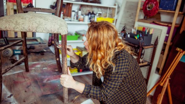 Young Adult Woman Restoring a Vintage Chair