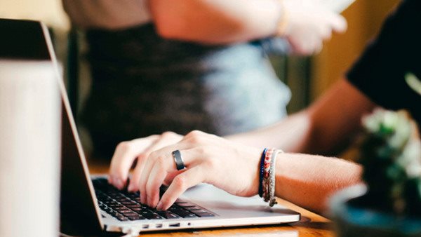 Hands working on a computer