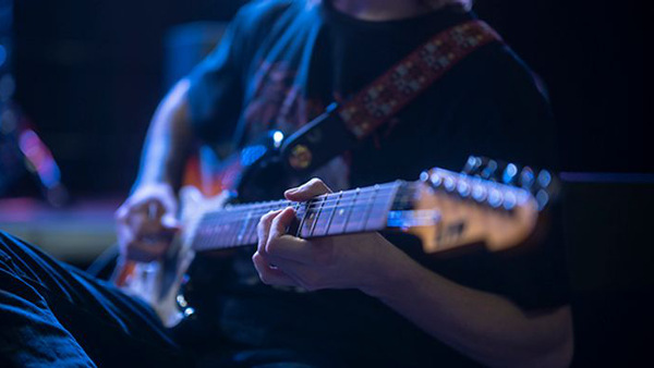 En man som spelar elgitarr