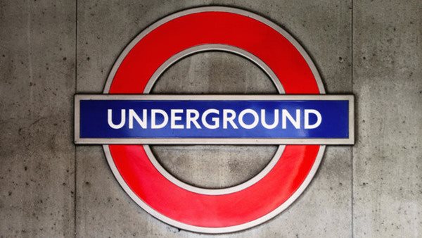 Cambridge English. London underground sign on a concrete wall