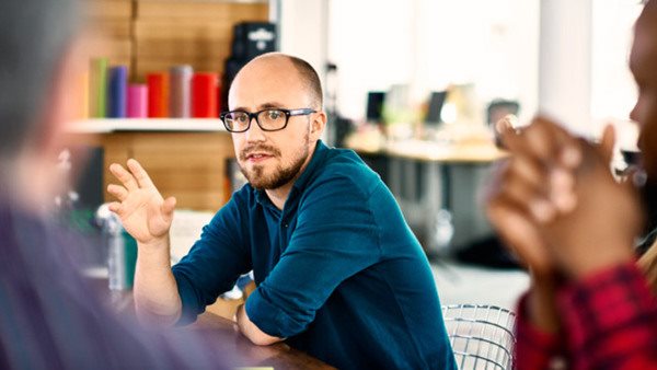 Man talking at business meeting in modern conference room