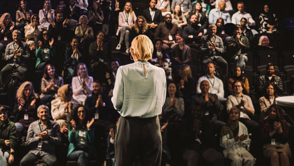 Kvinna som föreläser inför en publik