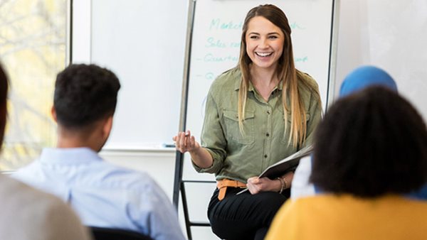 Smiling teacher leading a class –Study Swedish in Lund at Folkuniversitetet