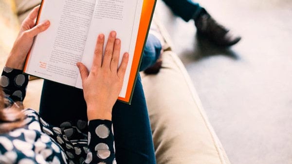A person on a couch studying for a language level test