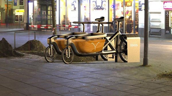 Animerad bild av transportcykel i stadsmiljö.