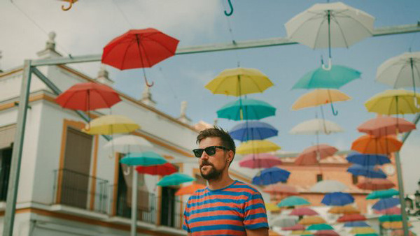 Man med solglasögon på en färgglad gata i Spanien dit vi bland annat har språkresor i spanska för vuxna