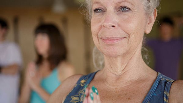 Close up of mature female in yoga class