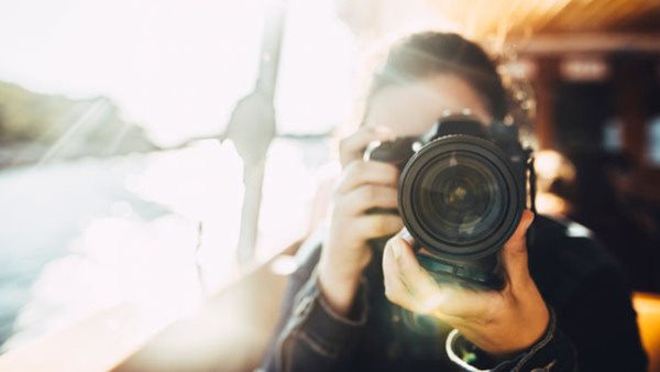 Young woman using a DSLR camera